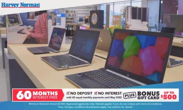Harvey Norman in-store computers display with 60 Months Interest Free banner
